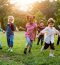 group-diverse-kids-playing-field-together_53876-78365